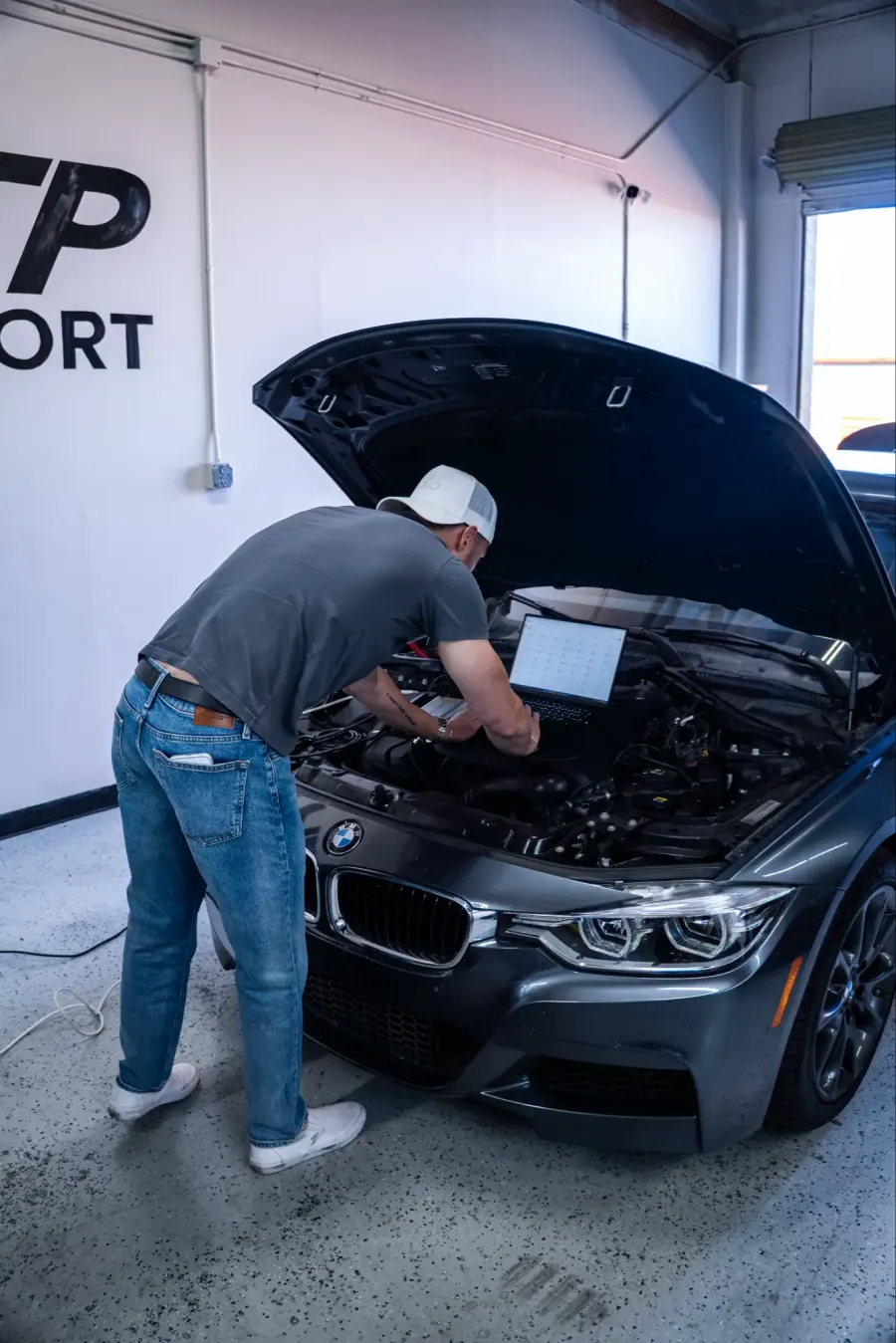 Technician running diagnostics on a BMW